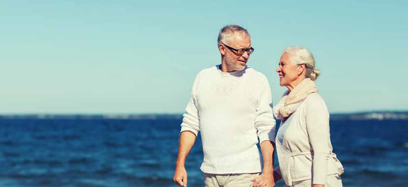 Couple walking in front of a body of water